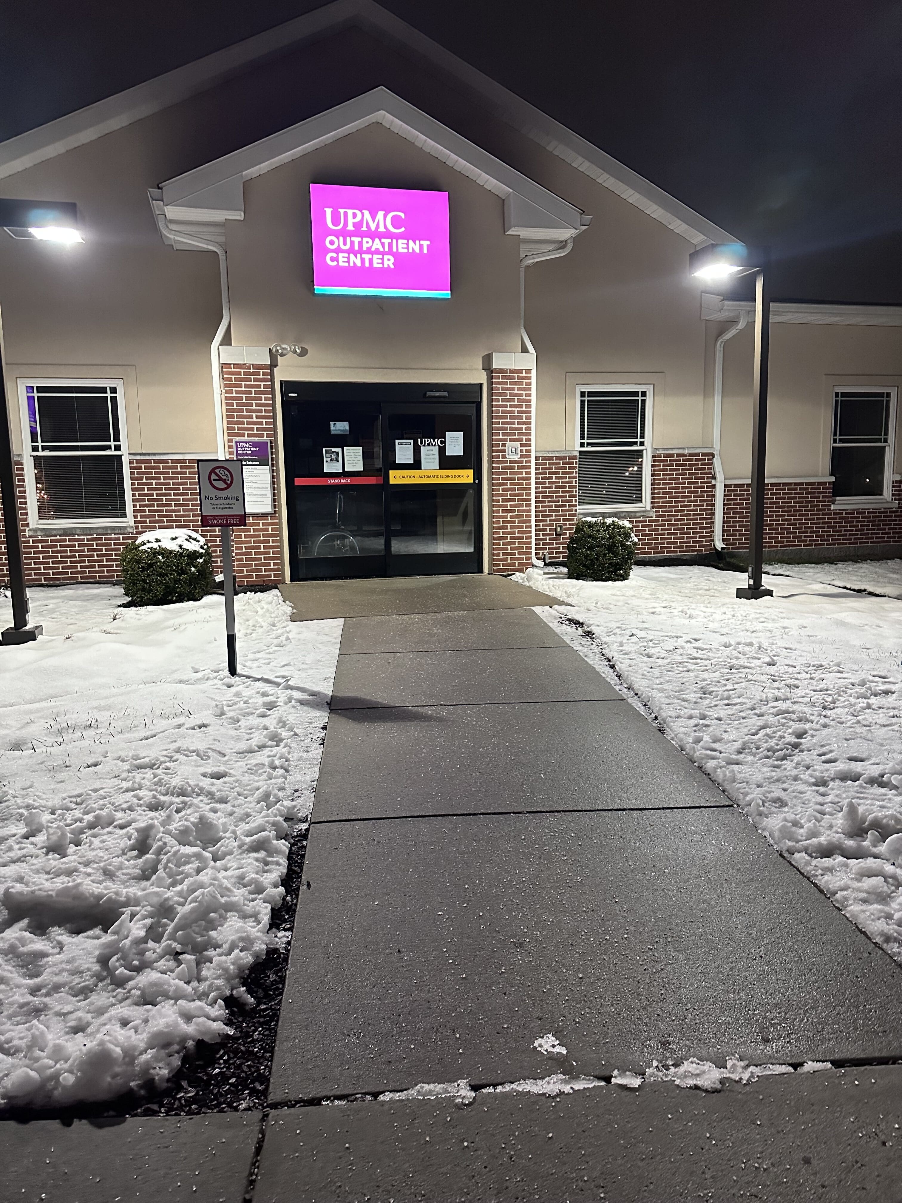A walkway leading up to a doctor's office has been cleared of snow.