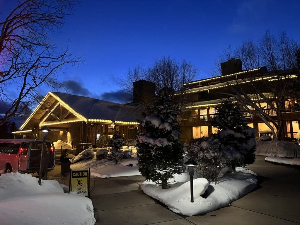 A business is illuminated against freshly cleared sidewalks