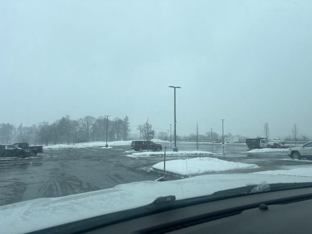 The view of a parking lot after it's been plowed.