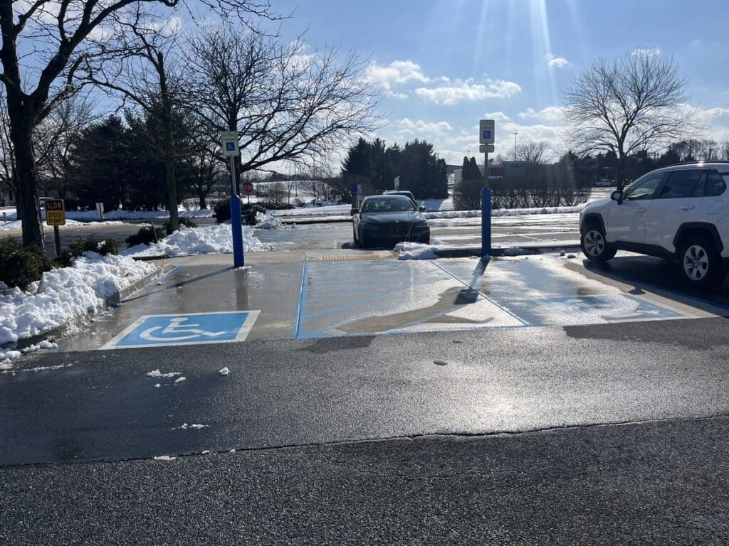 Handicapped spots are cleared of snow on both sides.