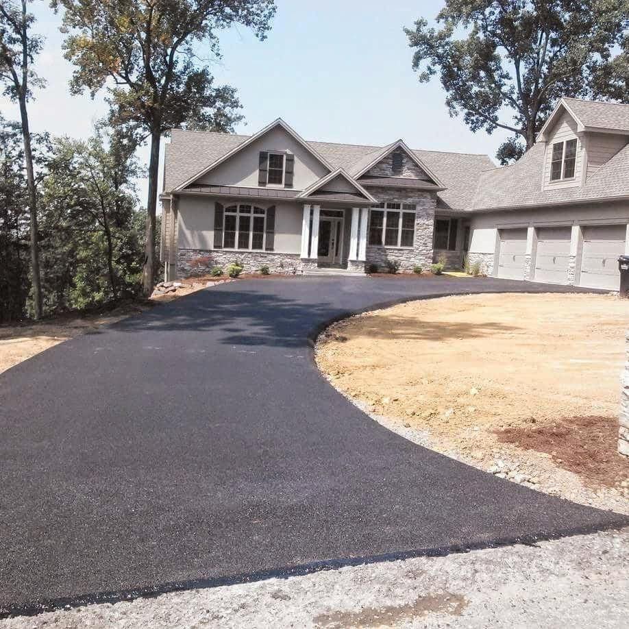 A paved driveway leading up to a home.